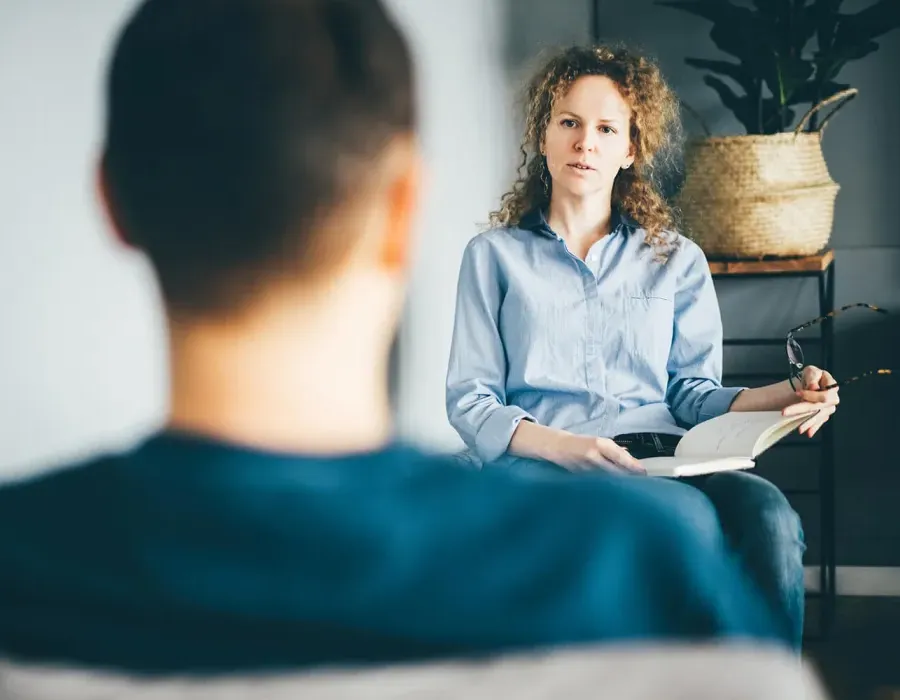 Social Worker Counseling with Client in Office